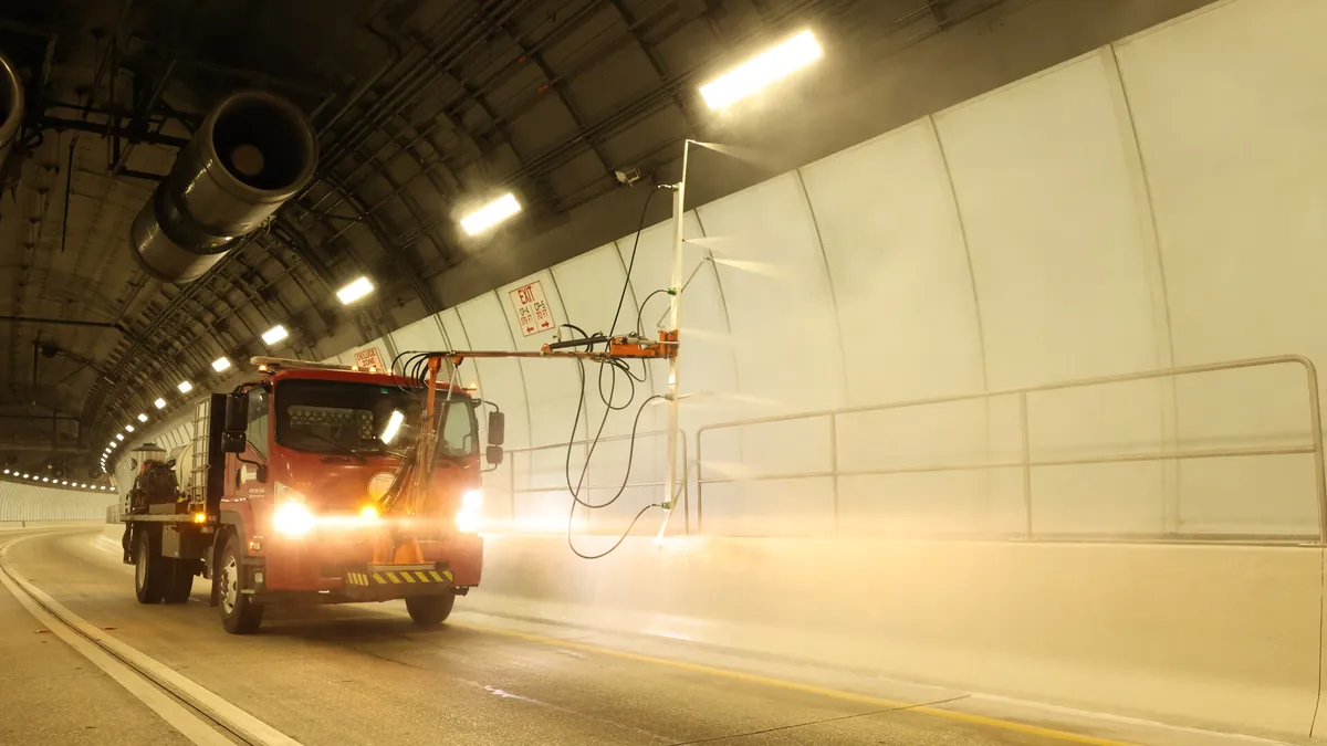 Florida Maintenance custom touchless wash truck spraying architectural panels inside the Miami Tunnel