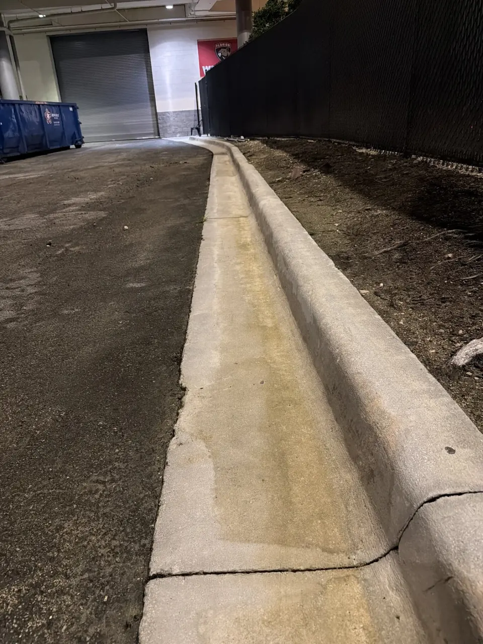 Parking garage curb and gutter after pressure cleaning