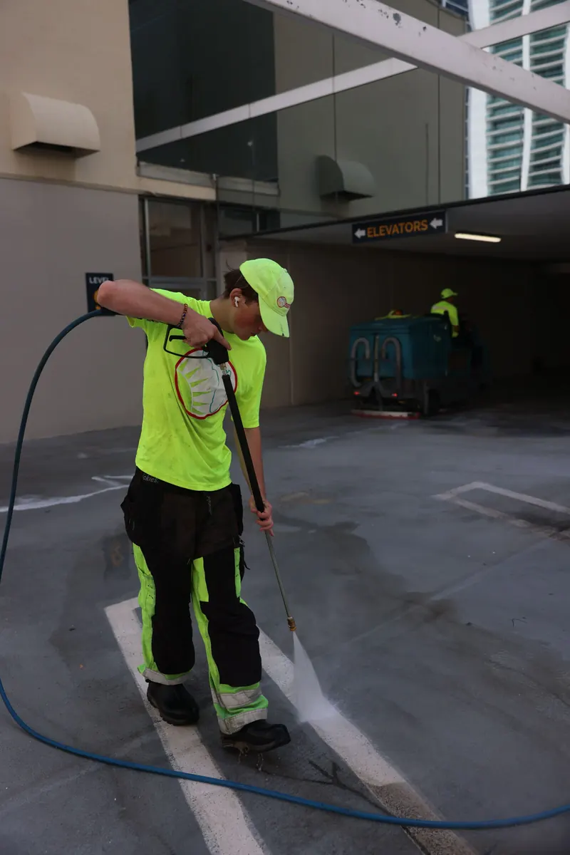Florida Maintenance crew pressure cleaning a parking garage ramp