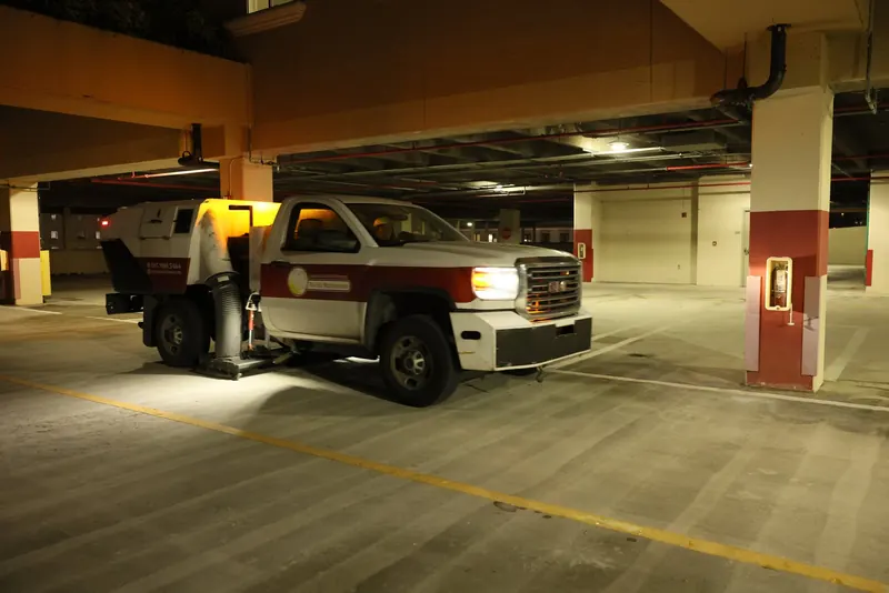 Florida Maintenance sweeper truck cleaning a parking garage
