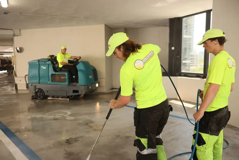 Florida Maintenance crew and a ride-on scrubber cleaning a parking garage