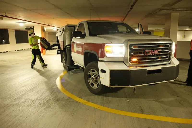 Sweeper truck and blower equipment in a parking garage
