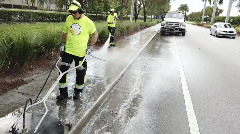 Florida Maintenance crew pressure cleaning a commercial sidewalk