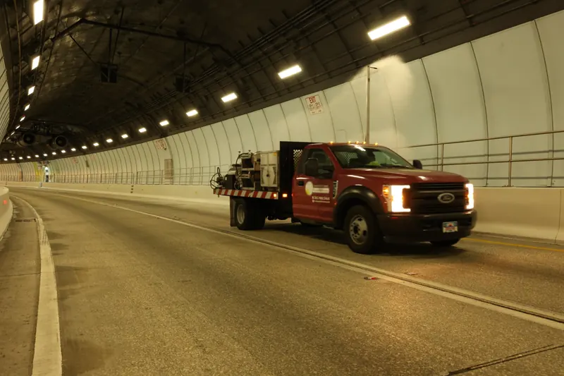 Florida Maintenance truck spraying wall panels inside a South Florida tunnel