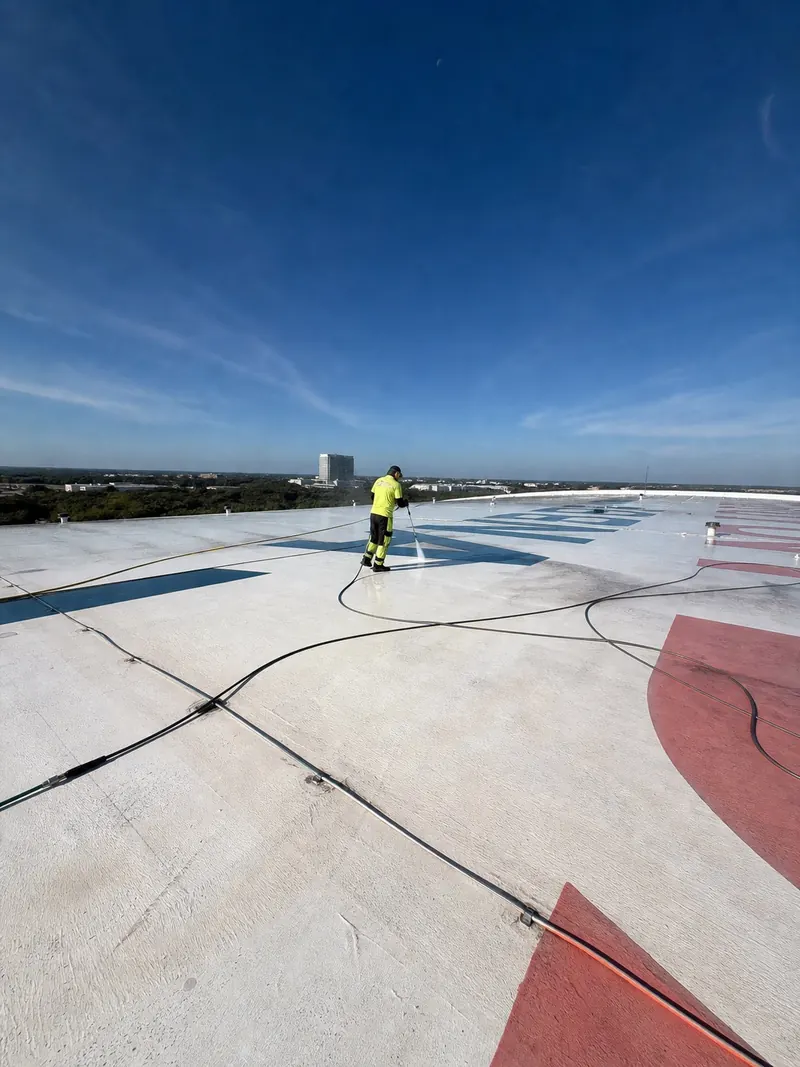 Florida Maintenance crew soft washing a commercial roof