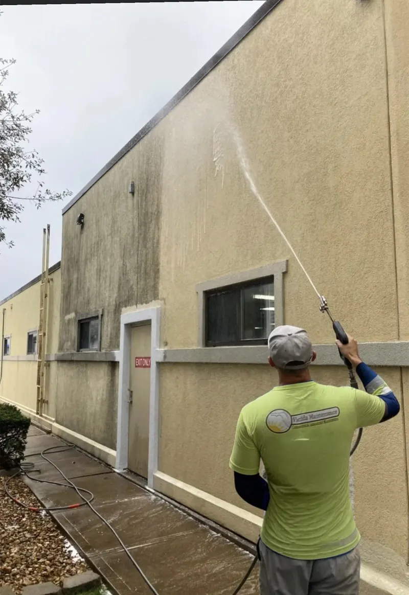 Florida Maintenance crew low-pressure washing a commercial wall