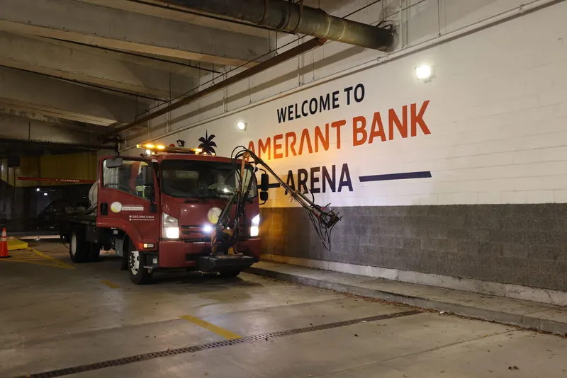 Pressure cleaning an arena service tunnel